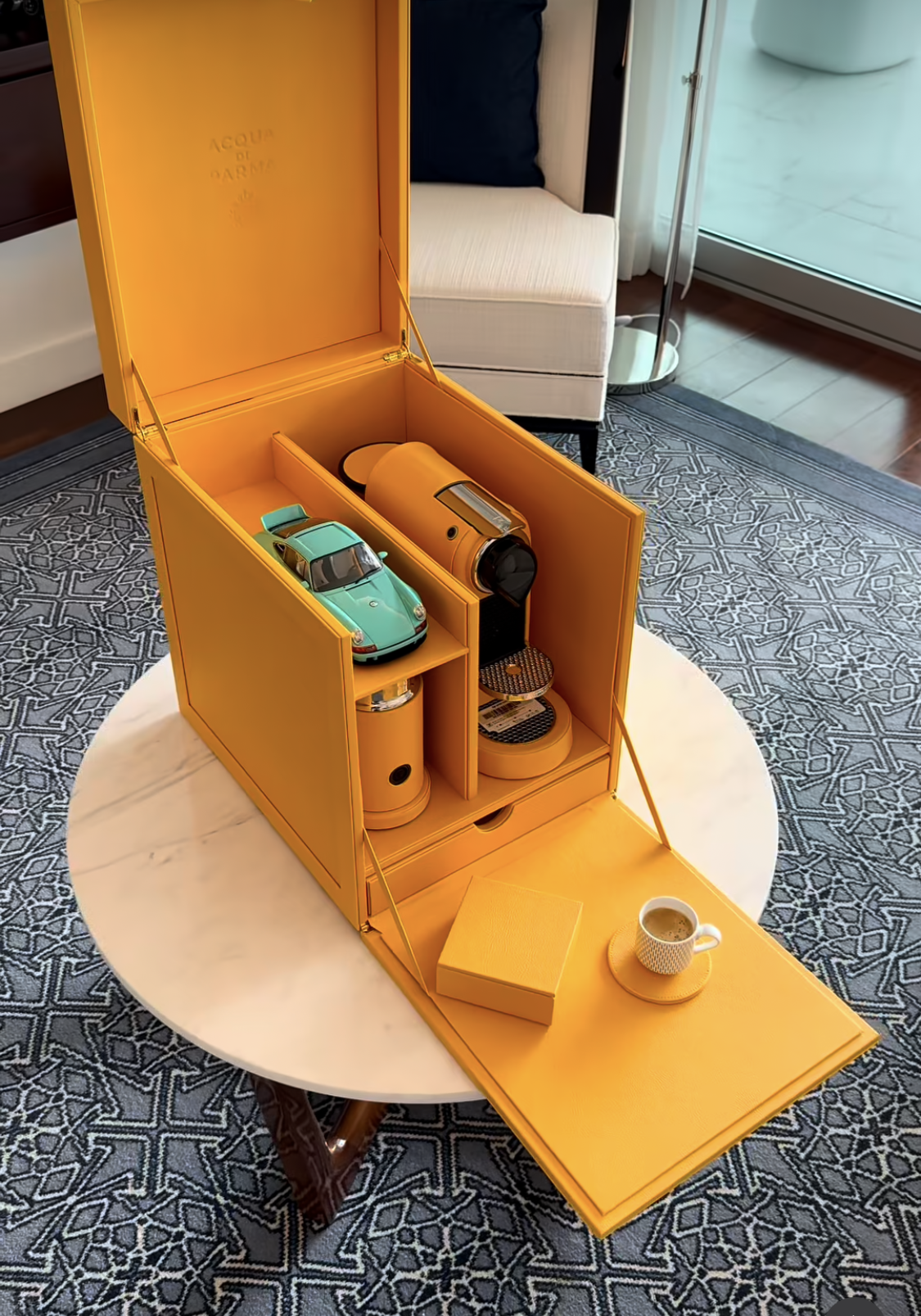 The Scrigno Chest in Saffron gold leather, opened to reveal the Nespresso machine and fitted compartments